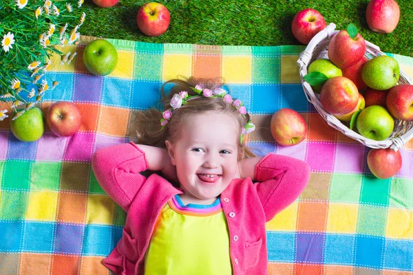 Little girl eating apples