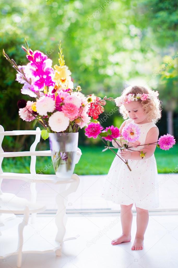 Little girl making flower arrangement