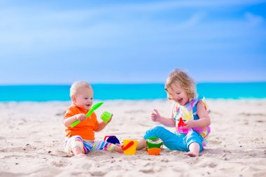 çocuklar bir plajda kumdan bir kale inşa