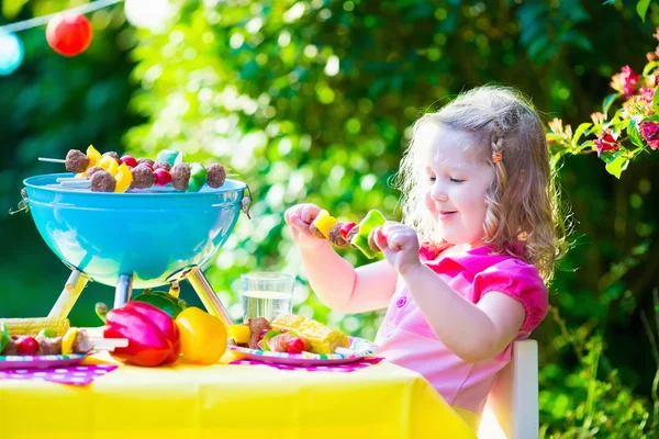 Little girl at garden grill party — Stock Photo, Image