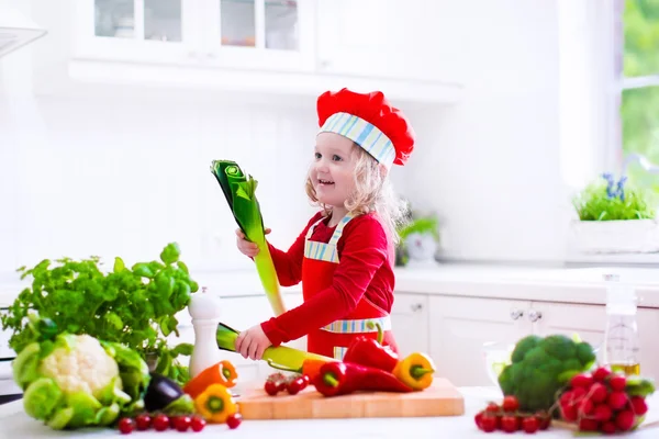 Little girl in chef hat preparing lunch — Stock Photo, Image