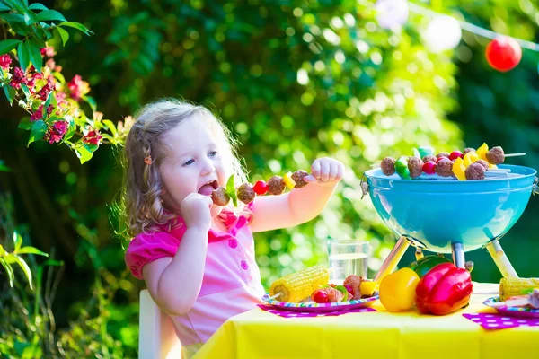 Little girl at garden grill party — Stock Photo, Image