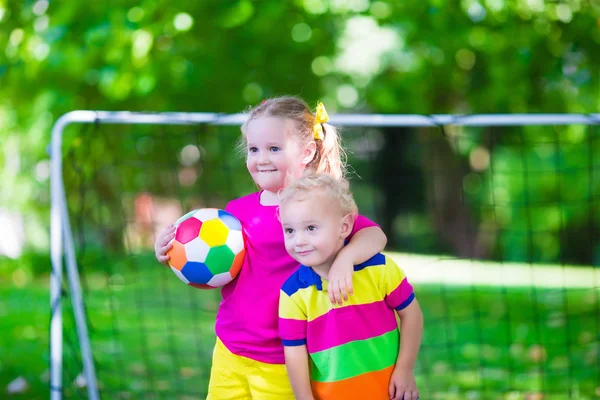 Kids playing football in school yard — Stock Photo, Image