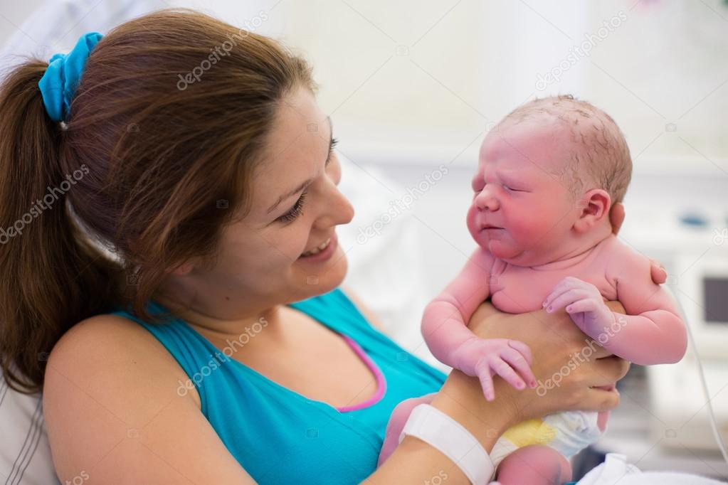 Young mother giving birth to a baby