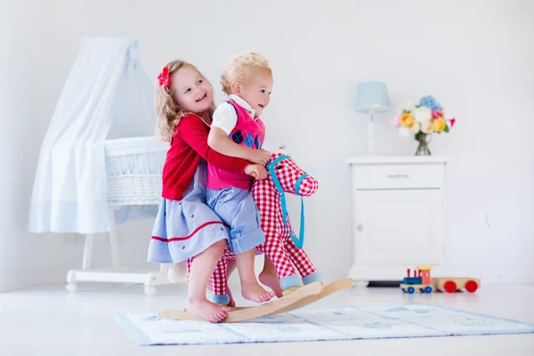 Kids playing with rocking horse — 图库照片