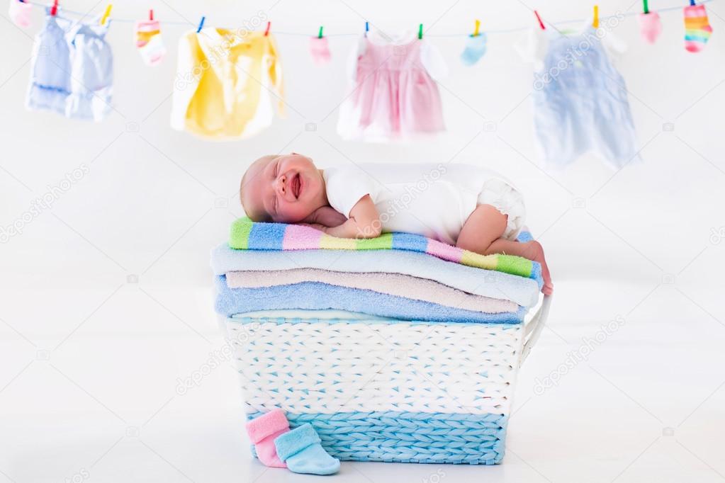 Newborn baby in a basket with towels