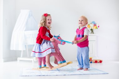 Kids playing with rocking horse