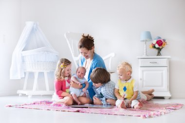 Mother and kids playing in bedroom