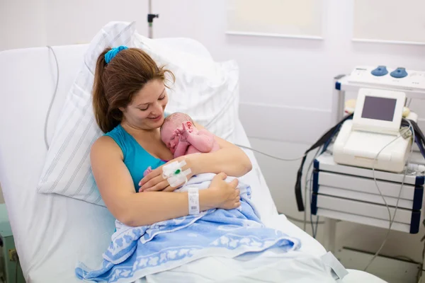 Young mother giving birth to a baby