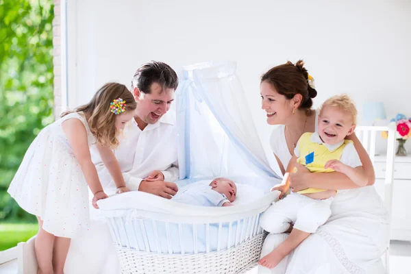 Family with kids playing with newborn baby — ストック写真