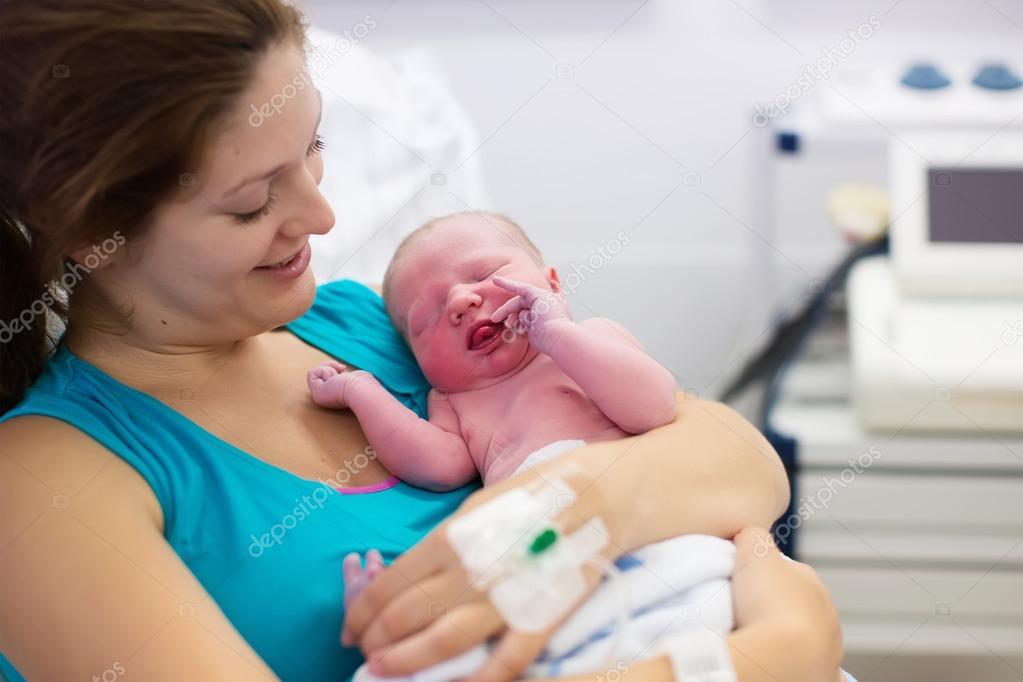 Young mother giving birth to a baby