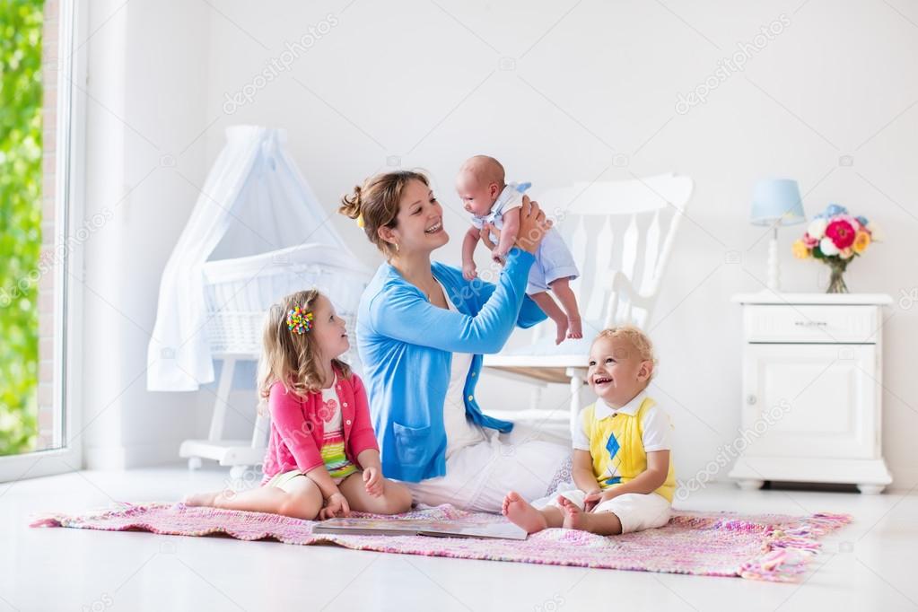 Mother and kids playing in bedroom