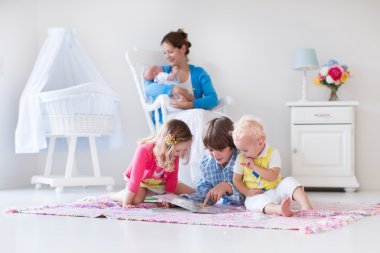 Mother and kids playing in bedroom