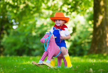 Child playing with a toy horse