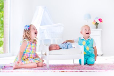 Kids playing with new born baby brother