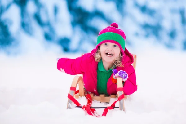 Little girl playing in snowy winter forest — Stock Photo, Image