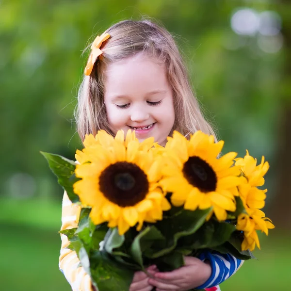 Little girl with sunflowers — Stock Photo, Image