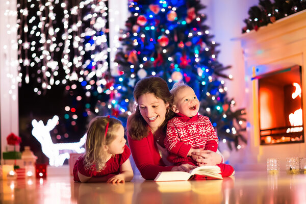 Mother and children at home on Christmas eve