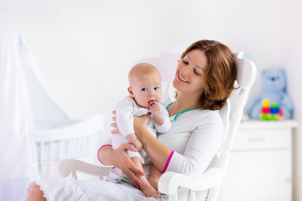 Mother and baby in white bedroom