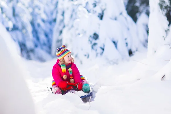 Little girl in snowy forest — Stock Photo, Image