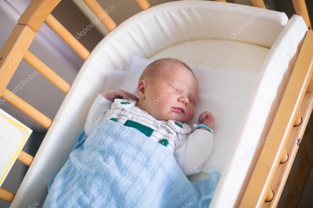 Newborn baby boy in hosptal cot 