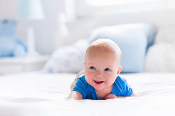 Baby boy in white sunny bedroom — Stock Photo, Image
