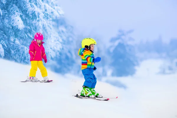 Deux enfants skient dans les montagnes enneigées — Photo