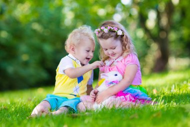 Kids playing with pet rabbit