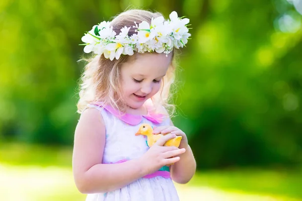 Little girl playing with a toy duck — Stock Photo, Image