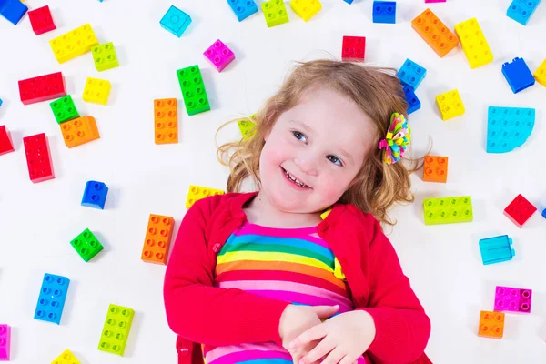 Little girl playing with colorful blocks — Stock Photo, Image