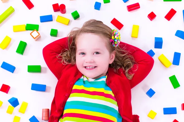 Little girl playing with wooden blocks — Stock Photo, Image