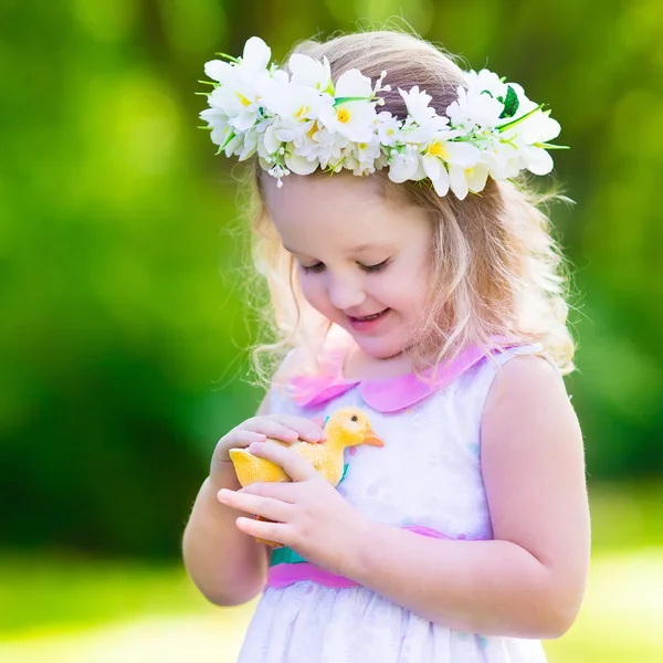 Little girl playing with a toy duck — Stock Photo, Image