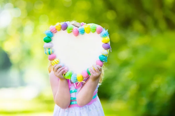 Little girl with white board for Easter greetings — Stock Photo, Image