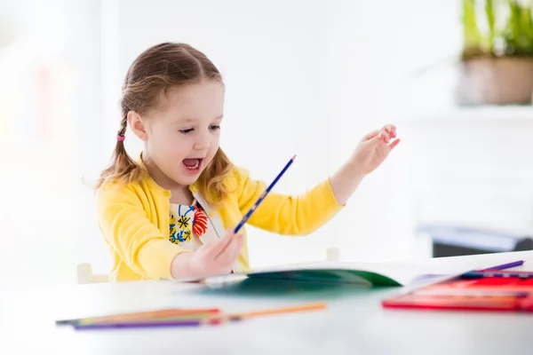 Klein meisje schilderen en schrijven — Stockfoto