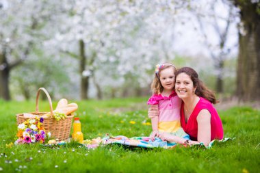 Family enjoying picnic in blooming garden