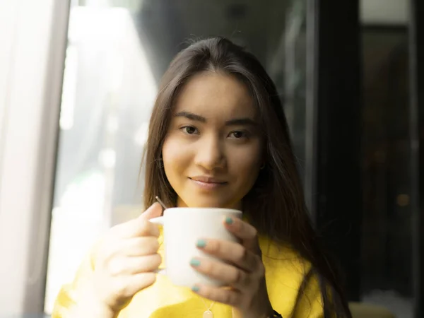woman having a coffee in a coffee shop asian girl