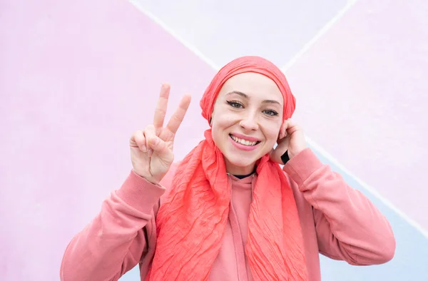 woman with cancer smiling pink scarf