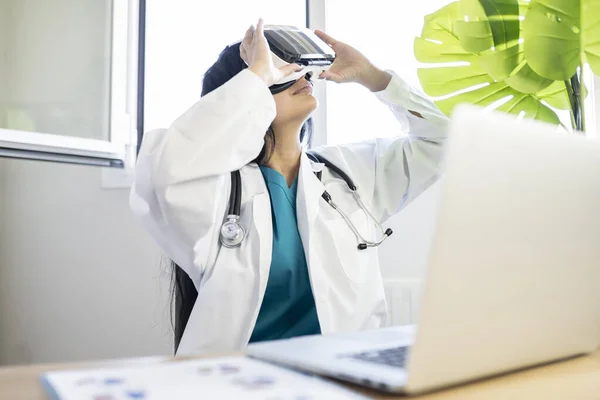 female doctor using virtual reality glasses technology in hospital