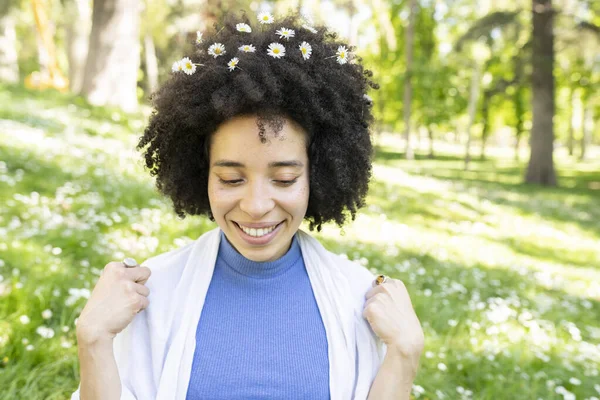 afro woman hair, covered with daisy flowers, spring concept