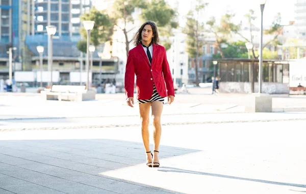 transvestite man with skirt, and heels, walking down the street