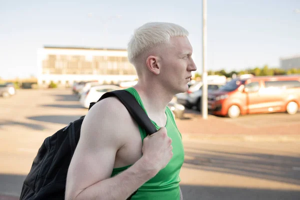 man with backpack goes to the gym