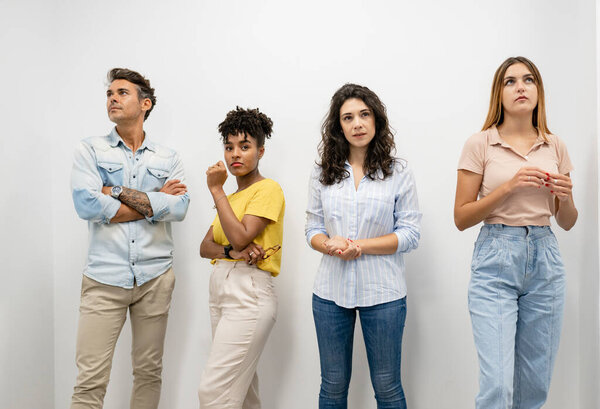 group of cowokring men and women standing on the wall