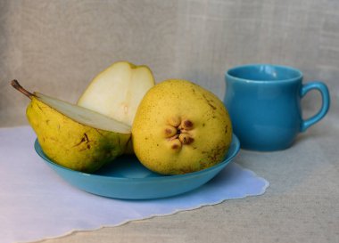 Yellow pears on a blue plate