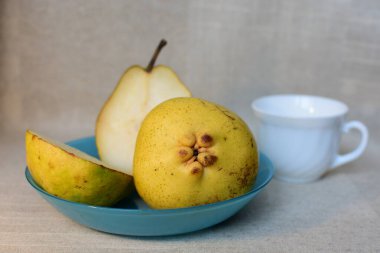 Yellow pears on a blue plate