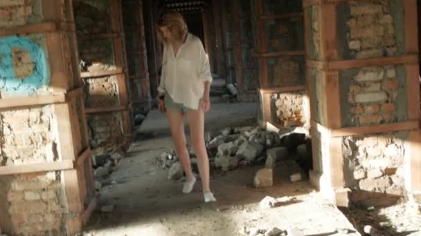 Girl model jumping up in an abandoned building. — Stock Video