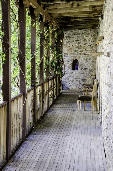 Old wooden Balcony and stone walls — Stock Photo, Image