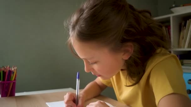 O portátil bonito do uso da criança para a instrução, estudo em linha, casa que estuda. Menina tem dever de casa na escola em casa. — Vídeo de Stock