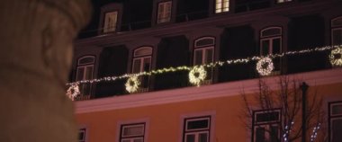 Noel, bir tatil döneminde ortaçağ cephesine karşı aydınlatılmış süslemeler. Yavaş çekim. 