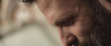 Mutfakta çalışan, sırıtan, sakallı bir İspanyol şefin fotoğrafını çek. Yavaş çekim.