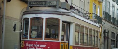 Lisbon, Portugal - Dec. 07, 2019: Traditional colorful public tram riding through the streets.